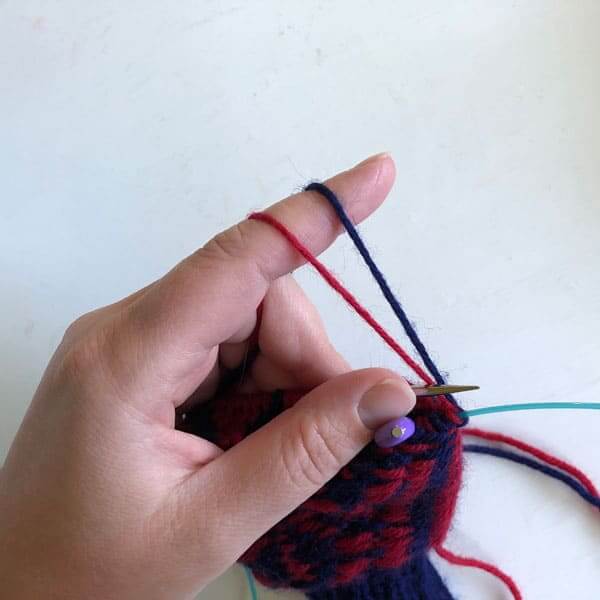 How I hold my yarn and project when knitting stranded colorwork as a continental knitter.