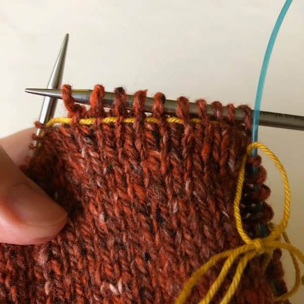 Here's what it looks like when the lifeline is added and I have knitted some of the stitches on the first row.
Adding a lifeline to a knitting with interchangeable needles. #HiyaHiya #Lifeline #knitting #knittingHacks