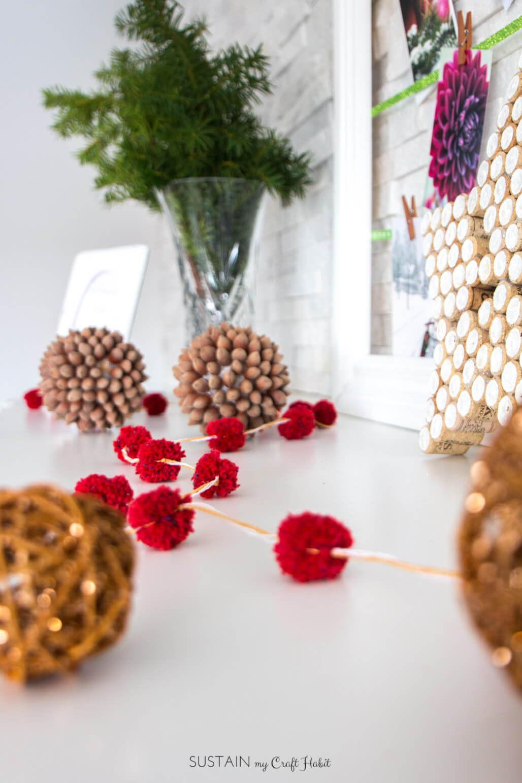 This mini pompom garland from red yarn makes a fun and cute decoration for christmas.