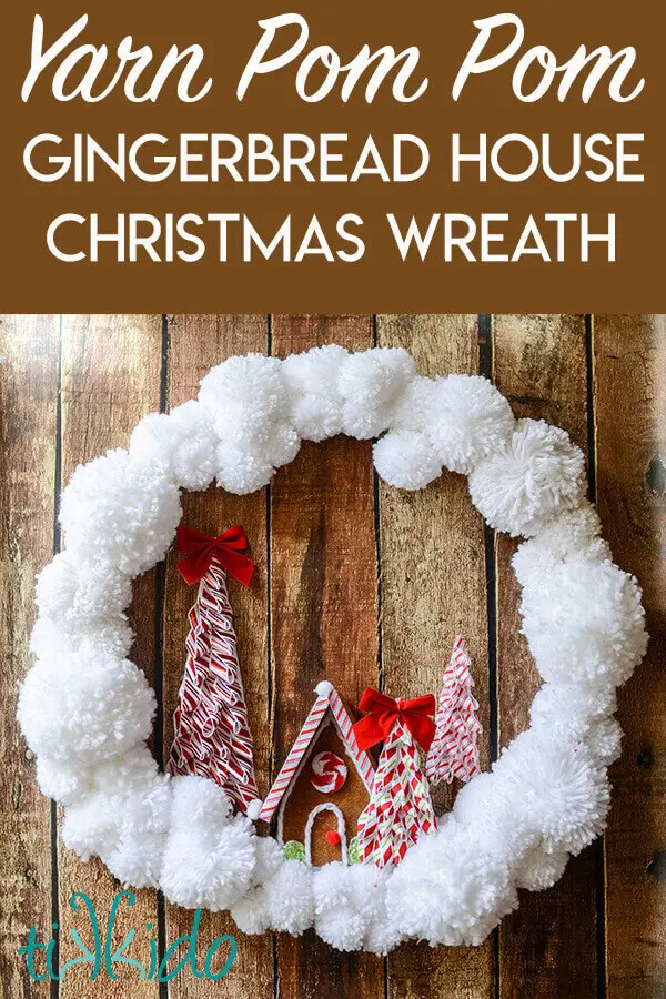 A Christmas wreath made of pompoms and a felt gingerbread house