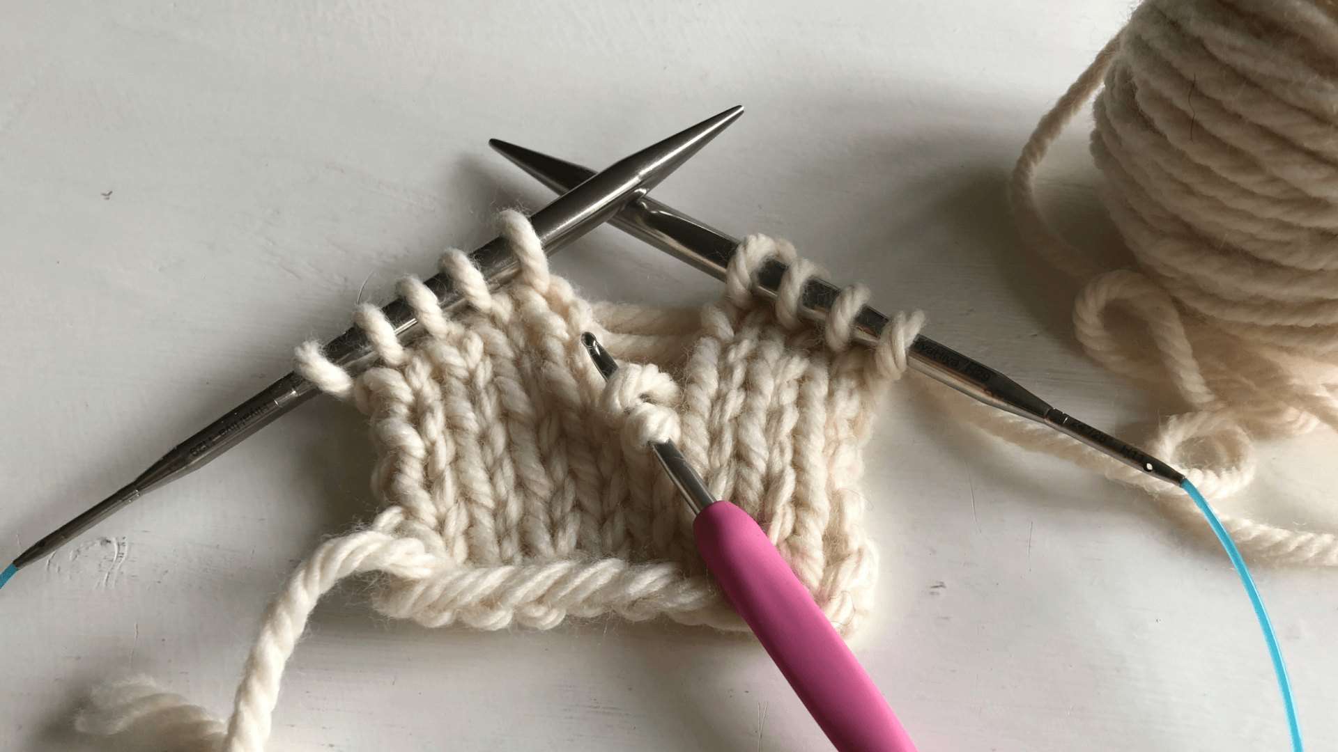 fix a dropped stitch by using the crochet hook to form new stitches all the way back up to the needle